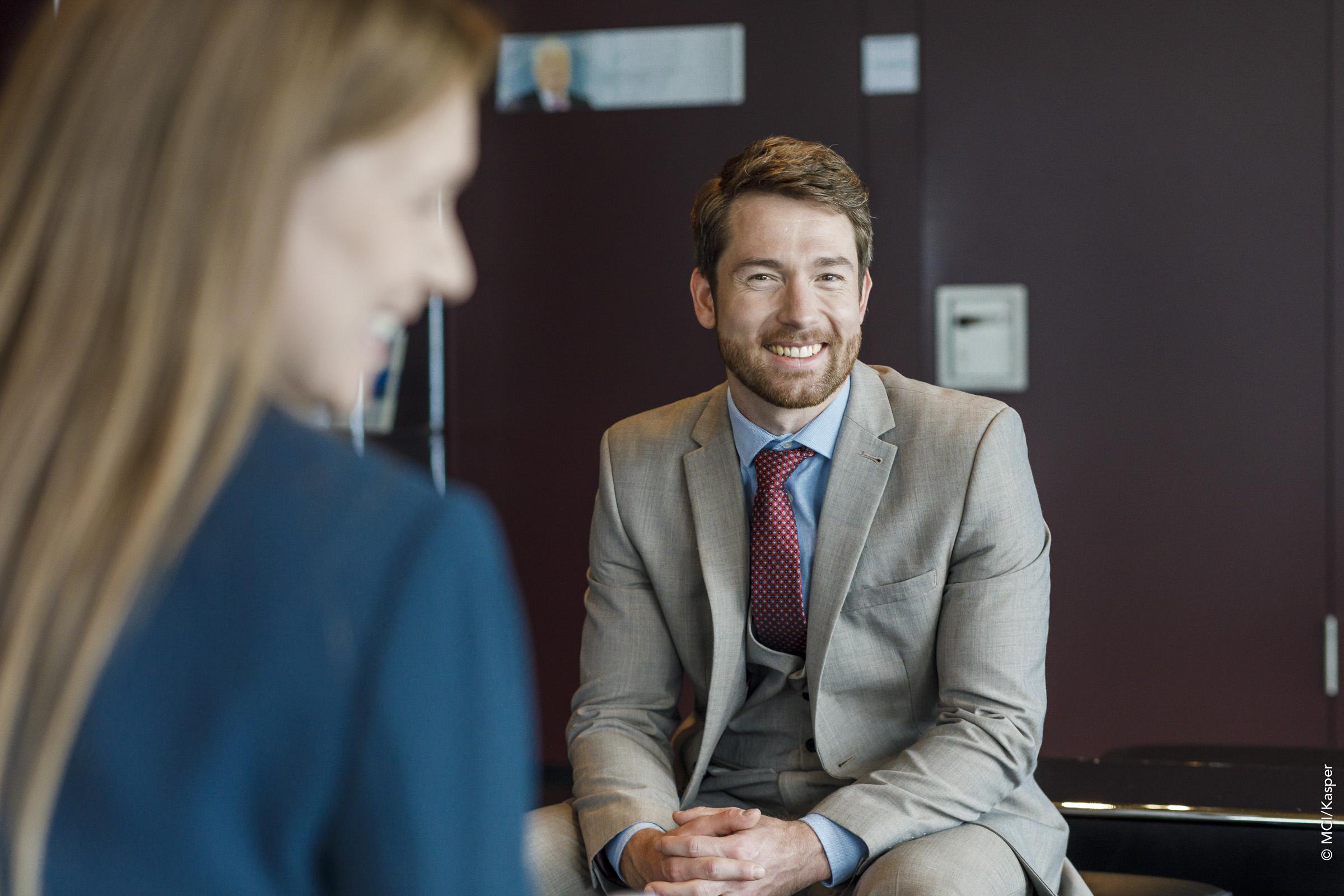 Executive Education student laughs into the camera