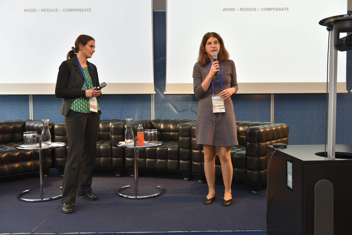 <p><em>Renate Windbichler and Julia Waldegger presenting the calculated carbon footprint of the conference. Photo: MCI/Koller</em></p>