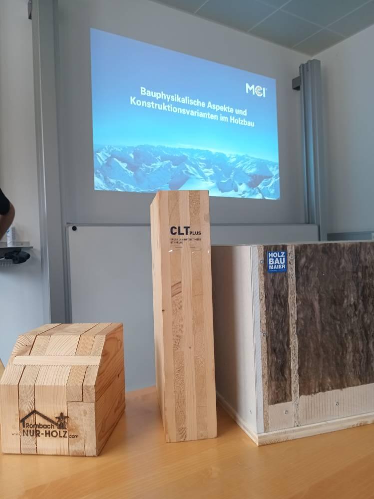 <p>The first afternoon lecture began with illustrative models: Jonas Seitner presented “Building physics aspects and construction variants in timber construction” by bringing along examples of “natural solid wood”, “solid wood” and the wall structure of the “timber frame construction” variant (from left to right). © MCI/Hofer</p>