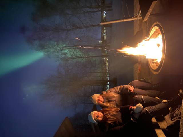 <p>Warm up by the campfire under the northern lights. Photo: Schwarzmann</p>